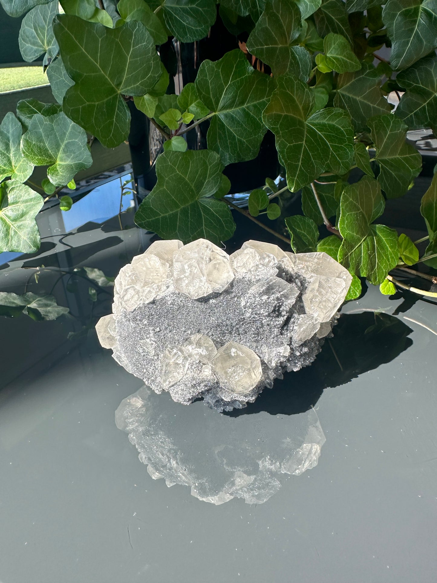 Clear Calcite Dodecahedron Cluster with Quartz Points on Hermatite