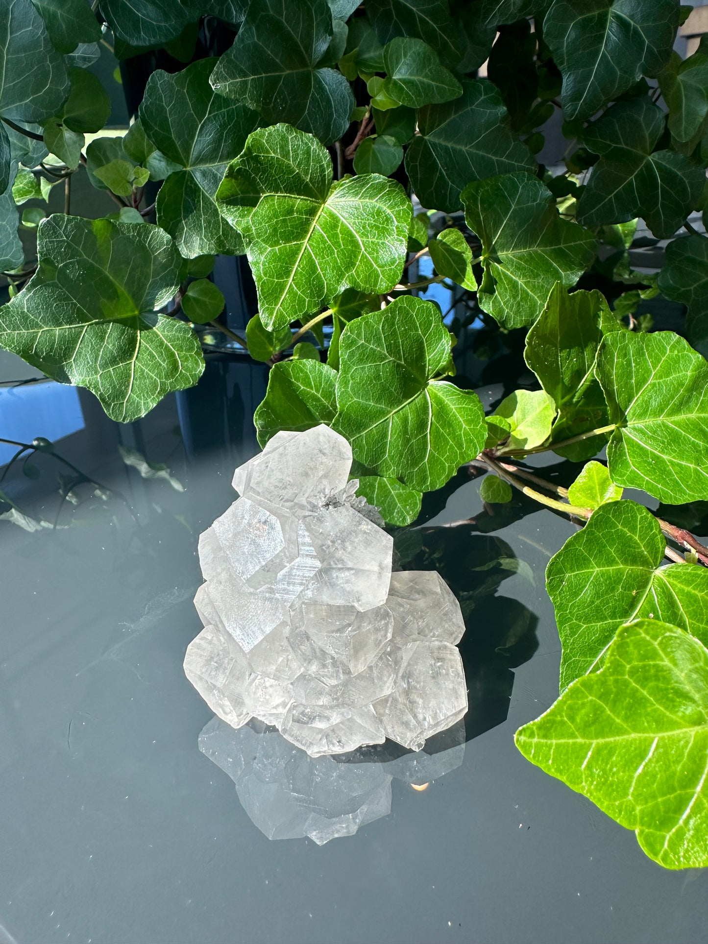 Clear Calcite Dodecahedron Cluster with Quartz Points on Hermatite