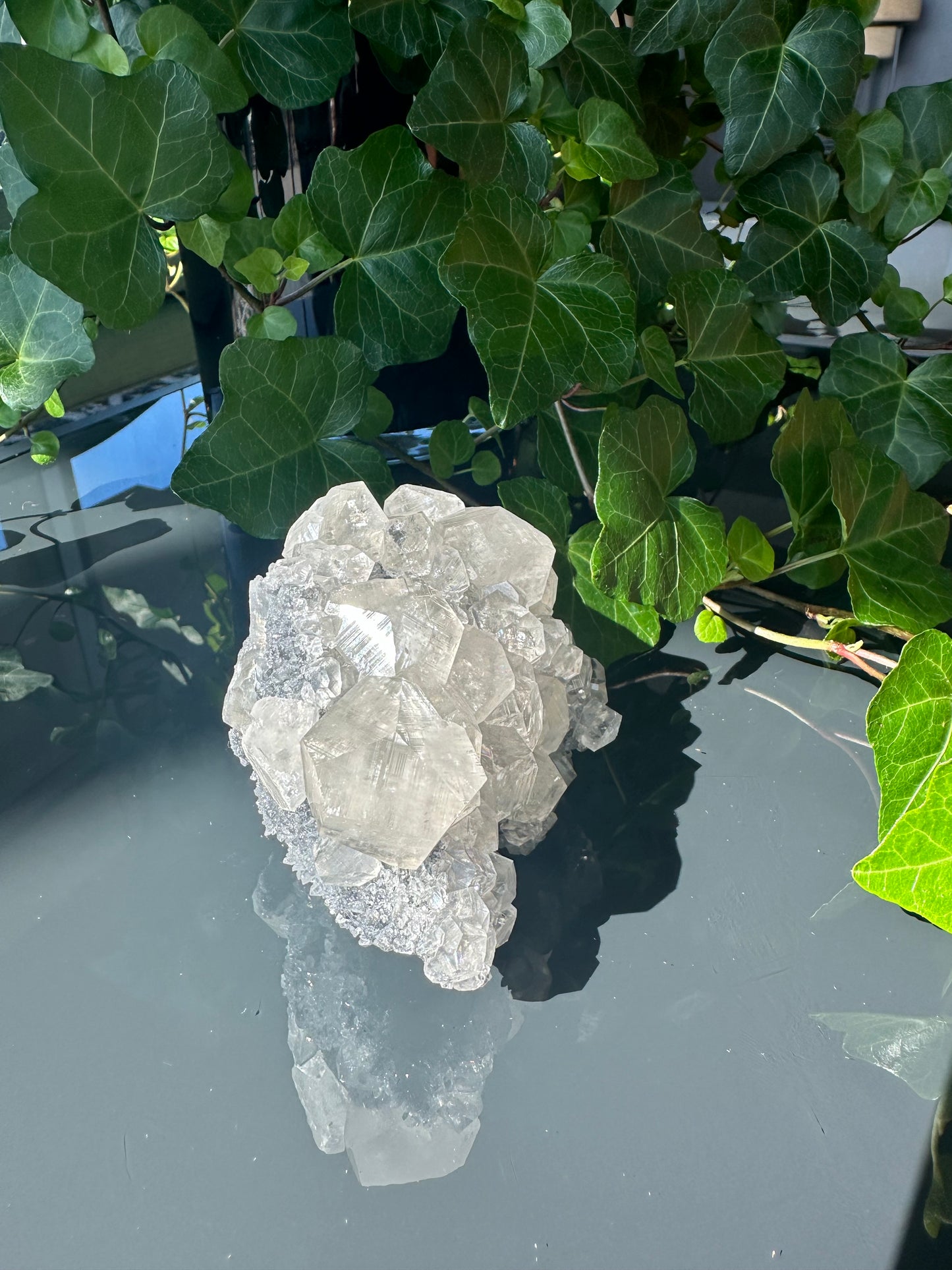 Clear Calcite Dodecahedron Cluster with Quartz Points on Hermatite