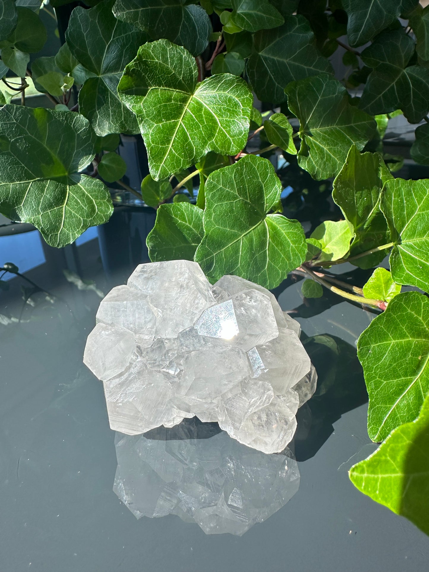 Clear Calcite Dodecahedron Cluster with Quartz Points on Hermatite