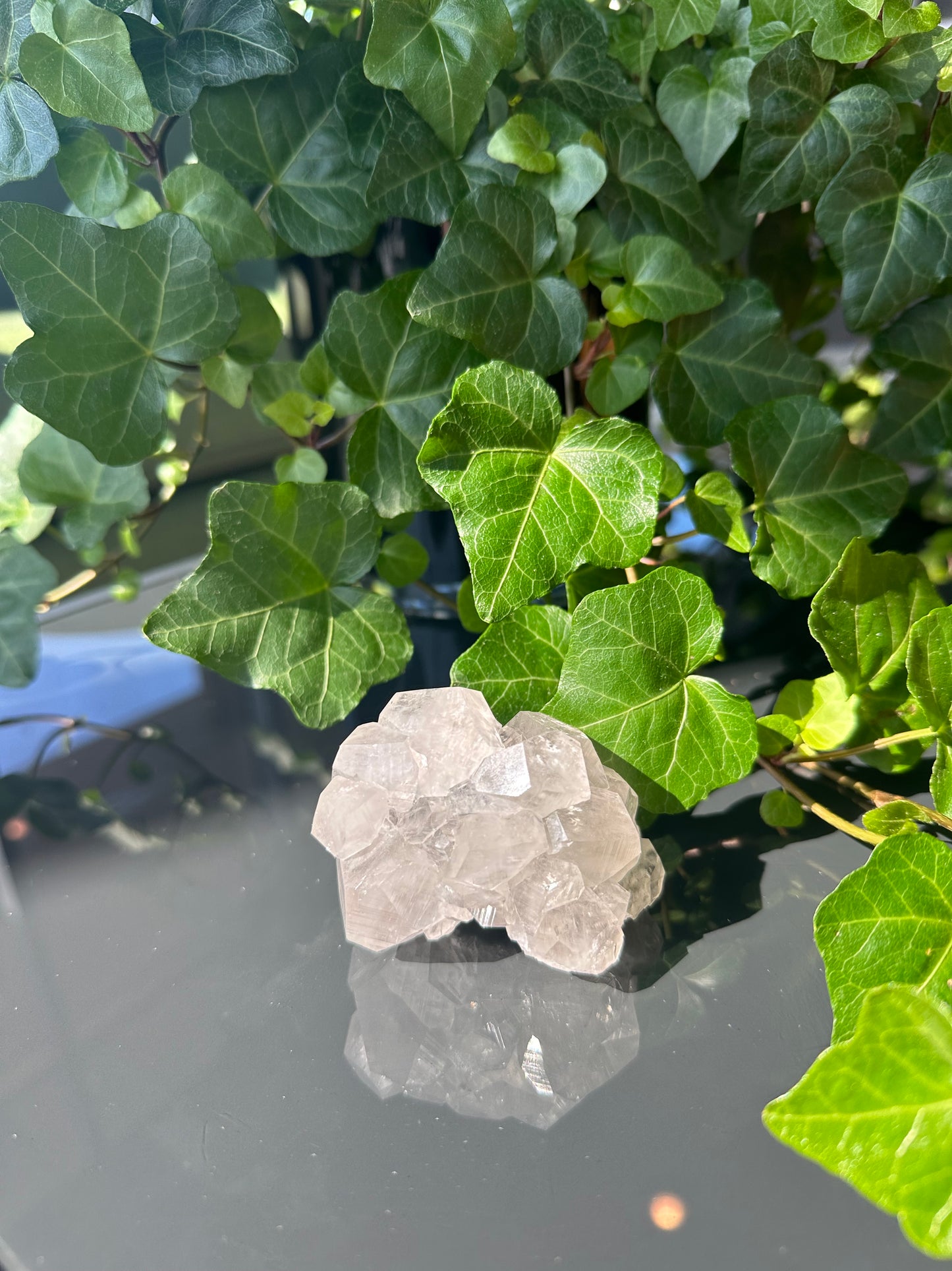 Clear Calcite Dodecahedron Cluster with Quartz Points on Hermatite