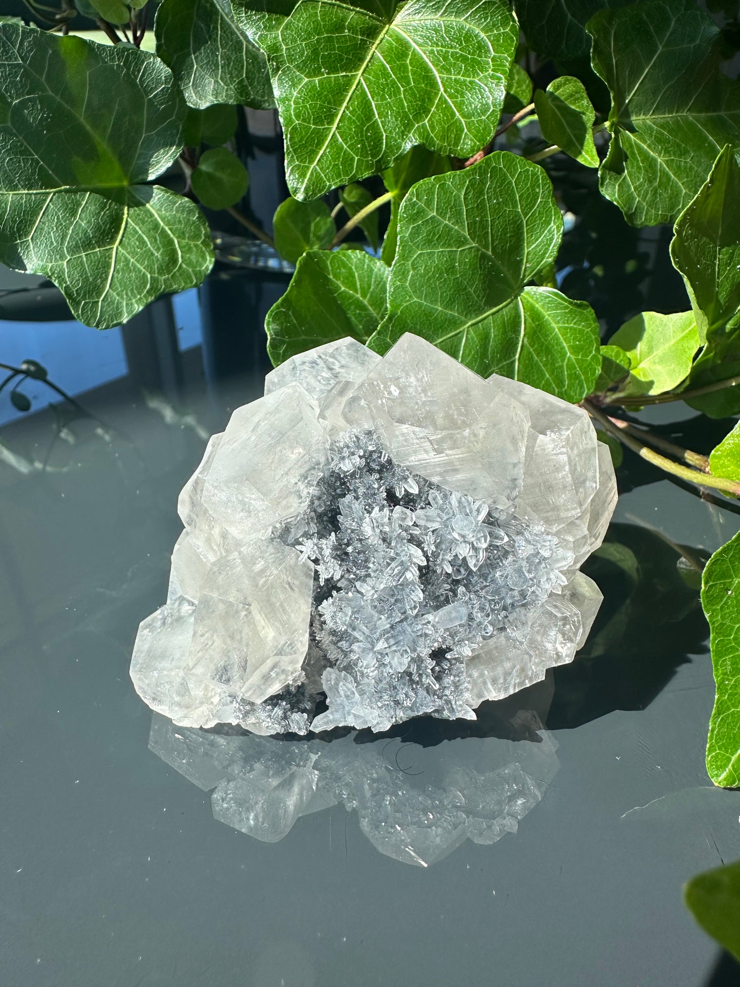 Clear Calcite Dodecahedron Cluster with Quartz Points on Hermatite