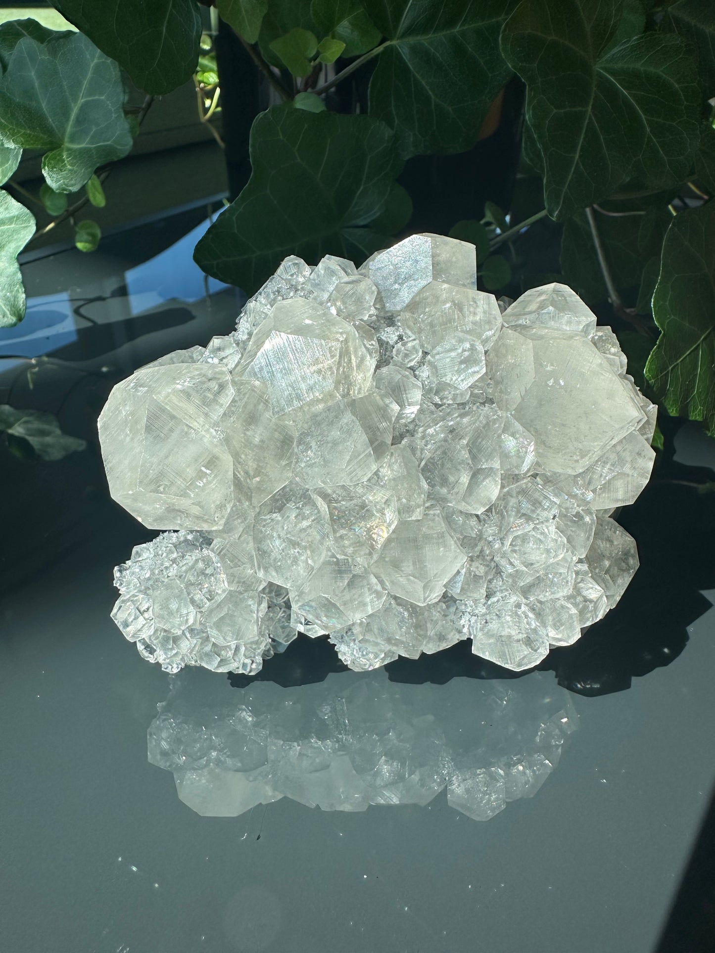 Clear Calcite Dodecahedron Cluster with Quartz Points on Hermatite