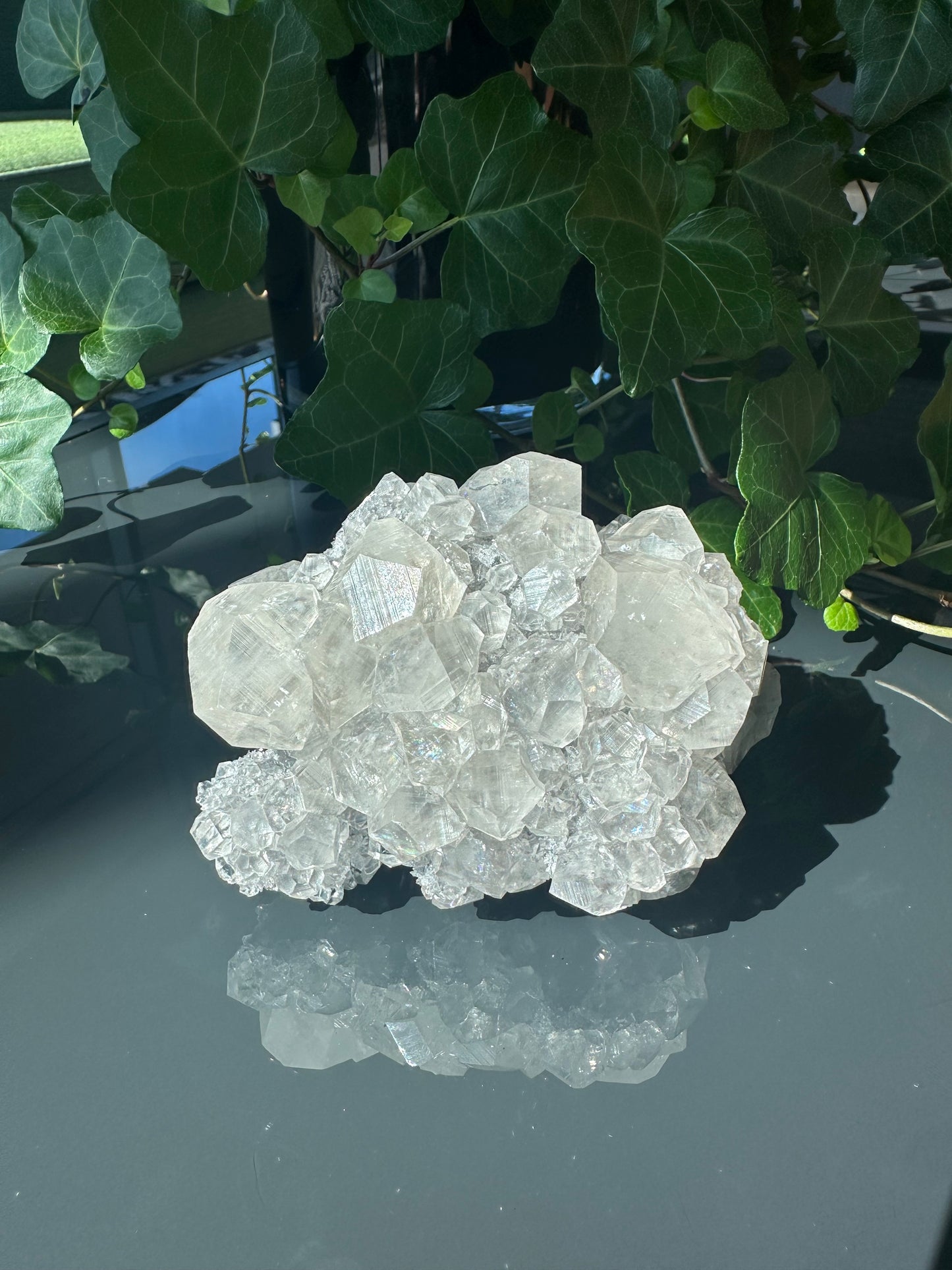 Clear Calcite Dodecahedron Cluster with Quartz Points on Hermatite