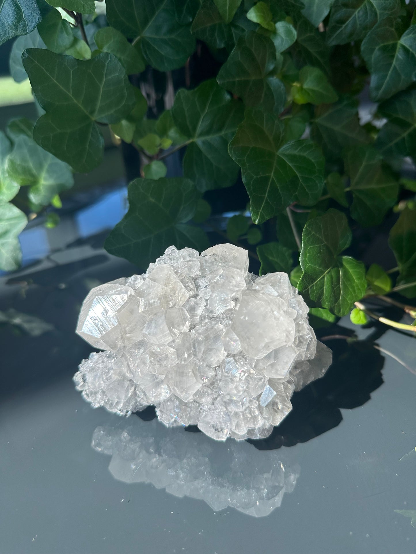 Clear Calcite Dodecahedron Cluster with Quartz Points on Hermatite